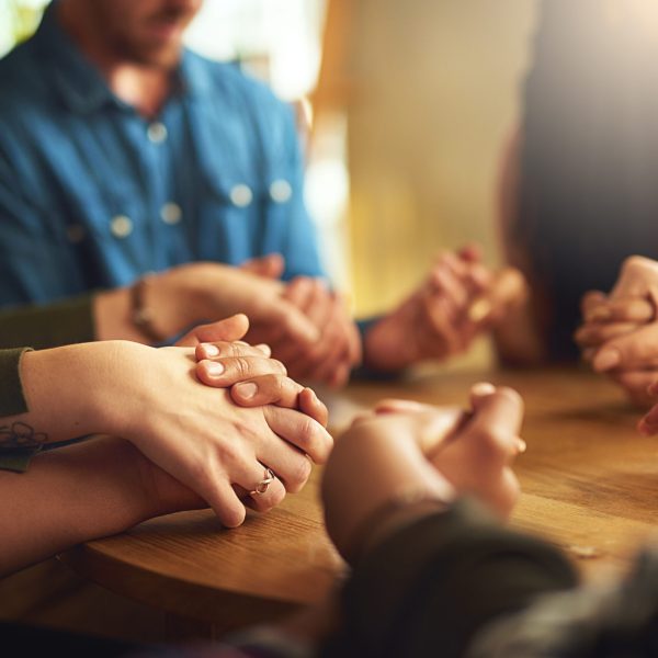 They share a strong faith group of people holding hands to pray